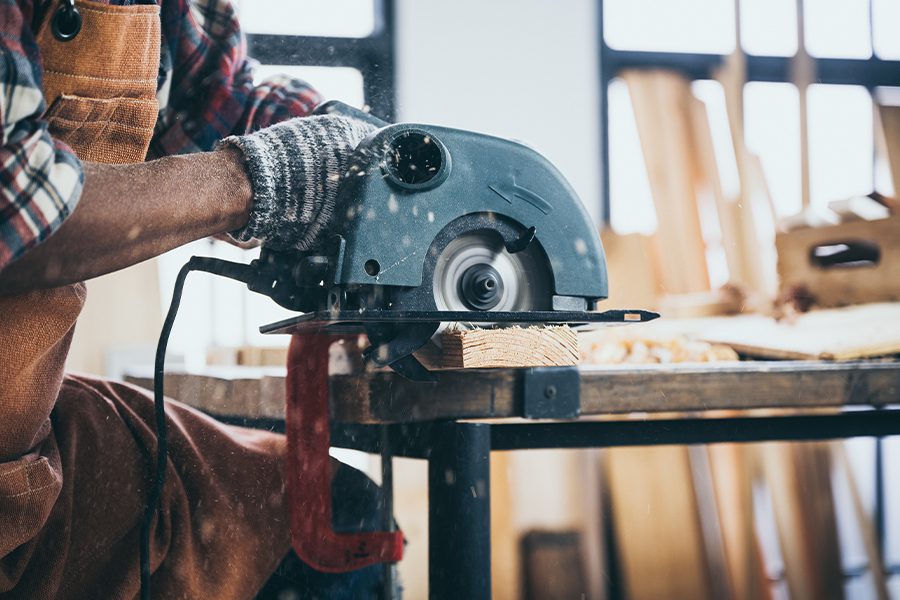 Specialized Business Insurance - A Close-up View of a Carpenter Using an Electric Circular Saw to Cut Wood